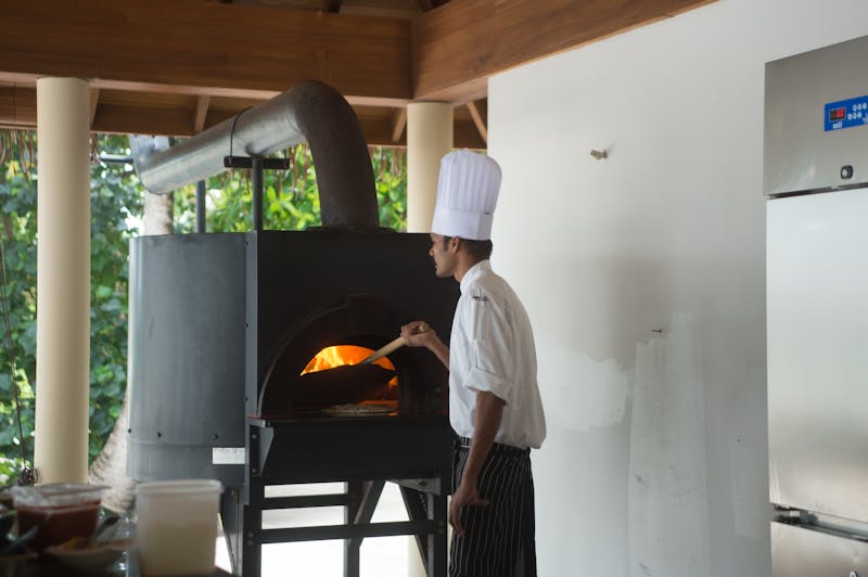 Coal fired pizza oven in action